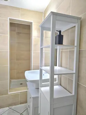 a white bathroom with a sink and a toilet at Tour Est - T2 entre Cité Médiévale et Bastide in Carcassonne