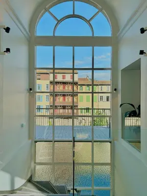 a room with a view of a building through a window at Grand Hotel de Castres in Castres