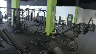 a gym with a bunch of tread machines in it at Grand Hotel de Castres in Castres