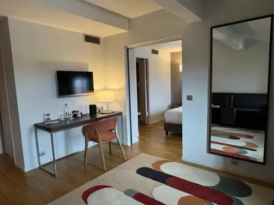 a hotel room with a desk and a mirror at Grand Hotel de Castres in Castres