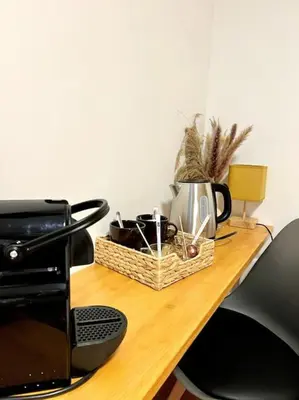 a wicker basket sitting on a table next to a microwave at Les chambres de la bastide - 201 in Carcassonne