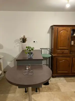a living room with a table and a cabinet at L'AAppartement in Montréal