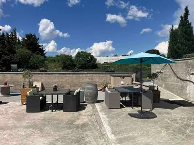a patio with two tables and an umbrella at L'AAppartement in Montréal