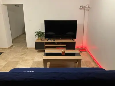 a living room with a flat screen tv on a table at L'AAppartement in Montréal