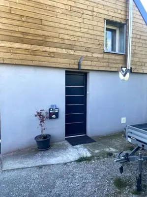 a building with a black door and a potted plant at L'AAppartement in Montréal