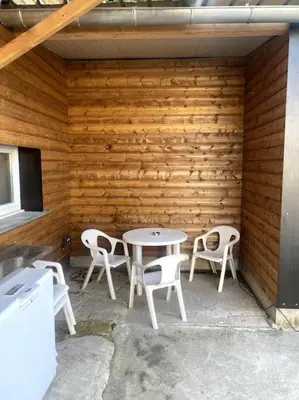 a patio with a table and chairs in a wooden wall at L'AAppartement in Montréal