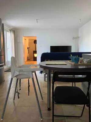 a dining table and chairs in a living room at L'AAppartement in Montréal