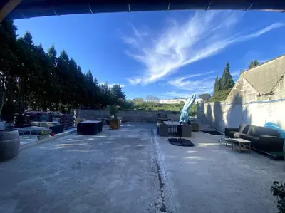 a patio with couches and tables and a wall at L'AAppartement in Montréal