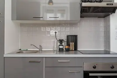 a kitchen with a sink and a counter top at Cocon de la Place in Villefranche-de-Lauragais