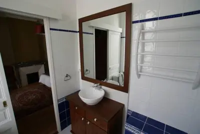 a bathroom with a sink and a mirror at Carcassonne Guesthouse in Carcassonne
