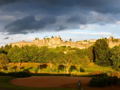 a large castle on top of a hill with trees at Carcassonne Guesthouse in Carcassonne