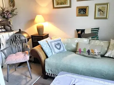a living room with a couch and a chair at Maison intime à Pouzols-Minervois avec jardin et parking in Pouzols-Minervois