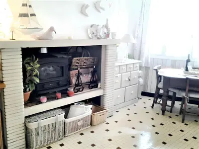 a living room with a fireplace and a table at Maison intime à Pouzols-Minervois avec jardin et parking in Pouzols-Minervois