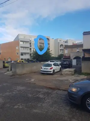 a car parked in a parking lot in front of a building at Peace and Quiet Mediterranean Wellbeing Bien-etre en Paix et calm in Narbonne