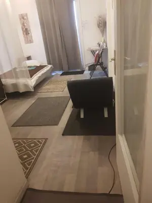 a hallway with a door open to a room with rugs at Peace and Quiet Mediterranean Wellbeing Bien-etre en Paix et calm in Narbonne