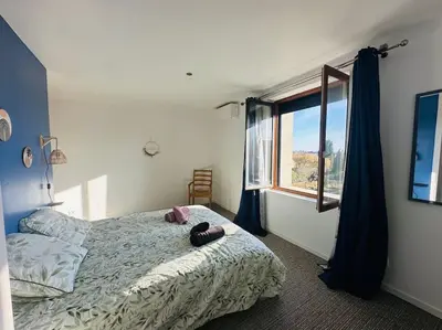 a bedroom with a bed with two slippers on it at Ancien chai rénové avec piscine in Paraza