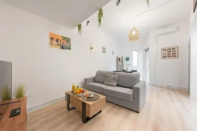 a living room with a couch and a coffee table at Spacieux T2 au centre ville avec parking et climatisation in Carcassonne