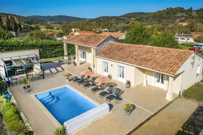 an aerial view of a house with a swimming pool at Villa Loupia by Villa Plus in Loupia