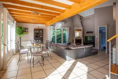 a kitchen and living room with a table and chairs at Villa Loupia by Villa Plus in Loupia