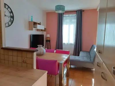 a living room with a table and a couch at Appartement spacieux à Lézignan-Corbières de 75 m² in Lézignan-Corbières