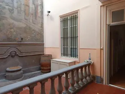 a staircase in a building with a large painting on the wall at Appartement spacieux à Lézignan-Corbières de 75 m² in Lézignan-Corbières