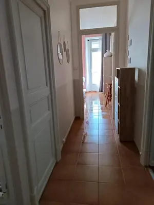 a hallway with a door and a tiled floor at Appartement spacieux à Lézignan-Corbières de 75 m² in Lézignan-Corbières