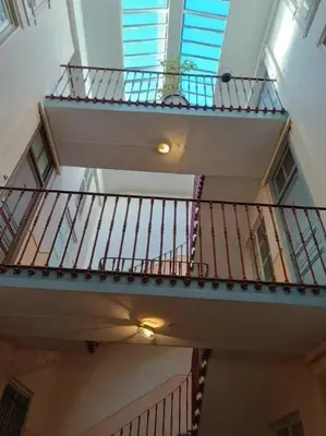 a spiral staircase in a building with a window at Appartement spacieux à Lézignan-Corbières de 75 m² in Lézignan-Corbières