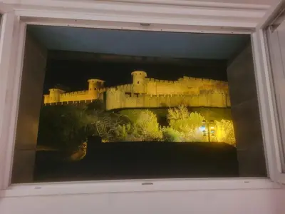 a reflection of a castle in a window at L'Observatoire-Cité Médiévale in Carcassonne