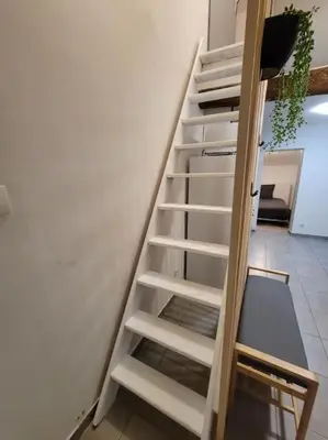 a white staircase next to a white wall at L'Observatoire-Cité Médiévale in Carcassonne