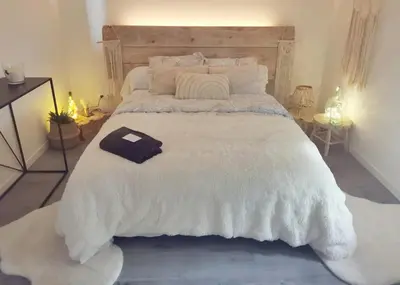 a bedroom with a large bed with a white comforter at Chez Nathalie&Maxime in Sorèze