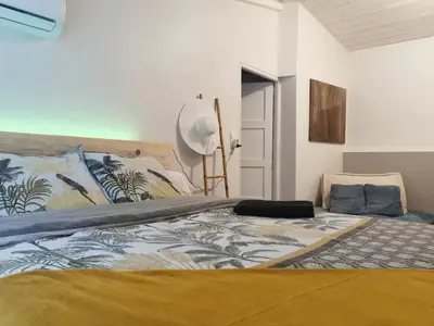 a bedroom with a large bed with a bedspread on it at Chez Nathalie&Maxime in Sorèze