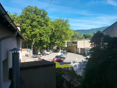 a view of a street with cars parked on the road at Le petit paradis in Saint-Pons-de-Thomières