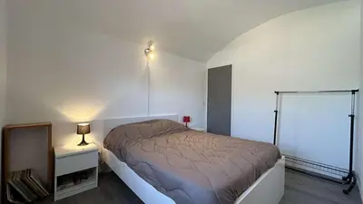 a bedroom with a bed and a lamp on a night stand at Joli pavillon - À deux pas de la plage du Grazel GA090-024 in Gruissan