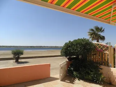 a view of the beach from the porch of a beach house at Front de plage du Grazel - Piscine et parking GN500-014 in Gruissan