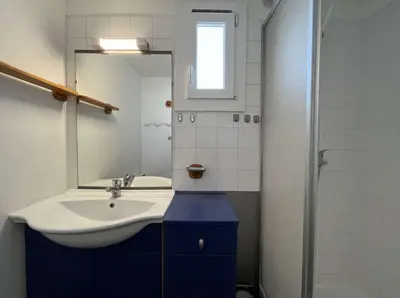 a bathroom with a sink and a mirror at Front de plage du Grazel - Piscine et parking GN500-014 in Gruissan