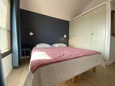a bedroom with a large bed with a pink blanket at Vue panoramique sur le port - Appartement 3 pièces GN110-C44 in Gruissan