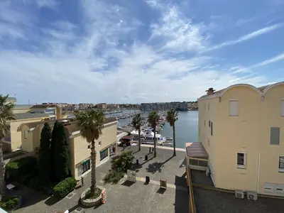 an aerial view of a building and a body of water at Vue panoramique sur le port - Appartement 3 pièces GN110-C44 in Gruissan