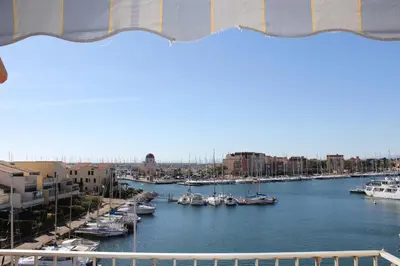 a view of a harbor with boats in the water at Appartement avec terrasse et jolie vue sur port GN580-033 in Gruissan