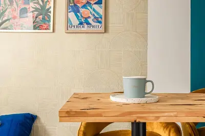 a table with a coffee cup on top of it at Studio Soleil d'Azur in Narbonne
