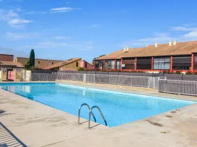 a large swimming pool in front of a building at Appartement dernier étage à 300 m de la plage GN020-238 in Gruissan