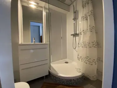 a white bathroom with a shower and a toilet at Appartement dernier étage à 300 m de la plage GN020-238 in Gruissan