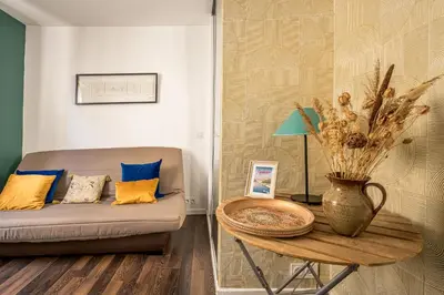 a living room with a couch and a table at Joli studio Narbonne in Narbonne