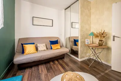 a living room with a couch and a table at Joli studio Narbonne in Narbonne