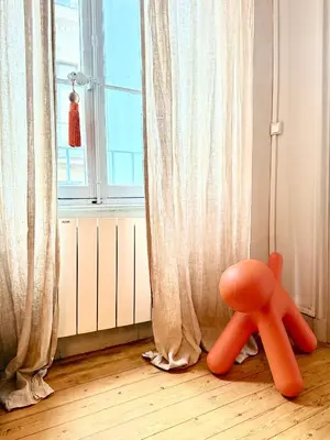 an orange object sitting on the floor in front of a window at Casa amore, cœur de ville in Carcassonne