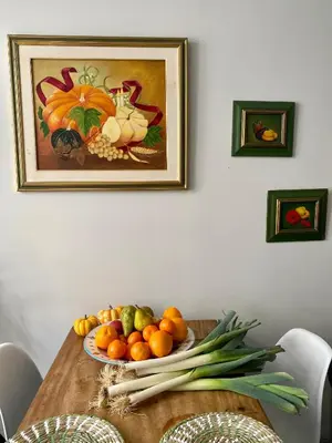 a table with a plate of fruit and vegetables on it at Casa amore, cœur de ville in Carcassonne