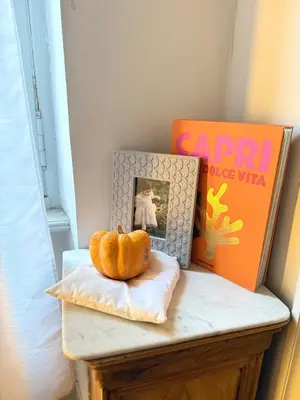 a pumpkin sitting on a table next to a book at Casa amore, cœur de ville in Carcassonne