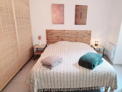 a bedroom with a bed with two pillows on it at Le Marceau Cour Extérieure in Narbonne