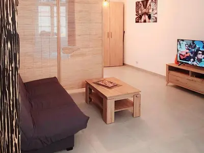 a living room with a couch and a coffee table at Le Marceau Cour Extérieure in Narbonne