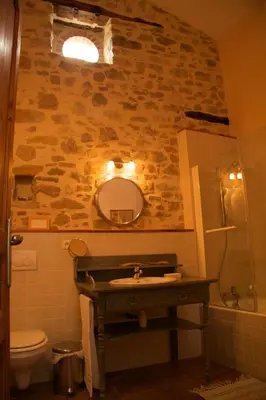 a bathroom with a sink and a mirror at La Maison des Couleurs in Saint-Jean-de-Paracol