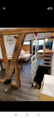 a room with a bunk bed and a clock on the wall at bel appartement in Mirepoix